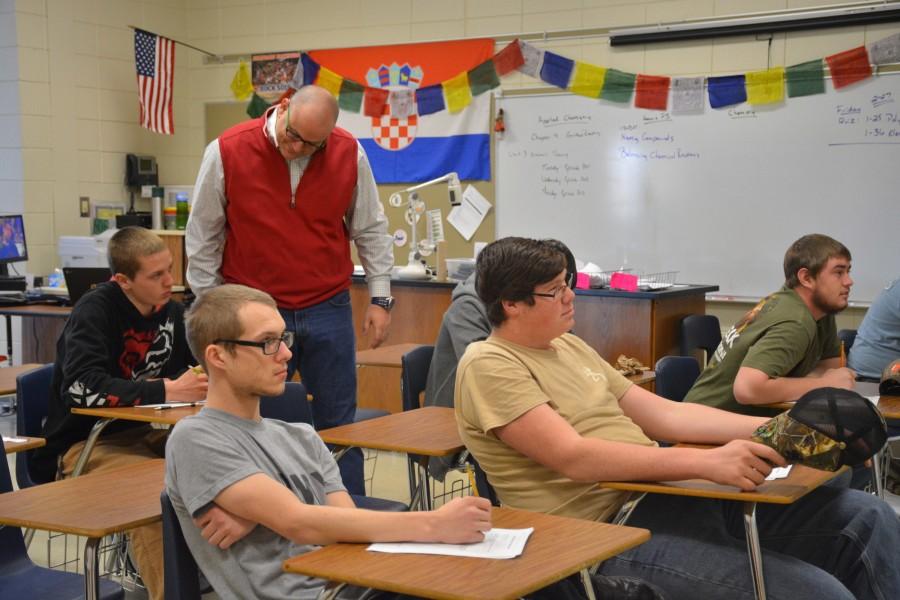 Science teacher Fred Brown explains content to his students. Brown completed his Ph.D. in 2014. 