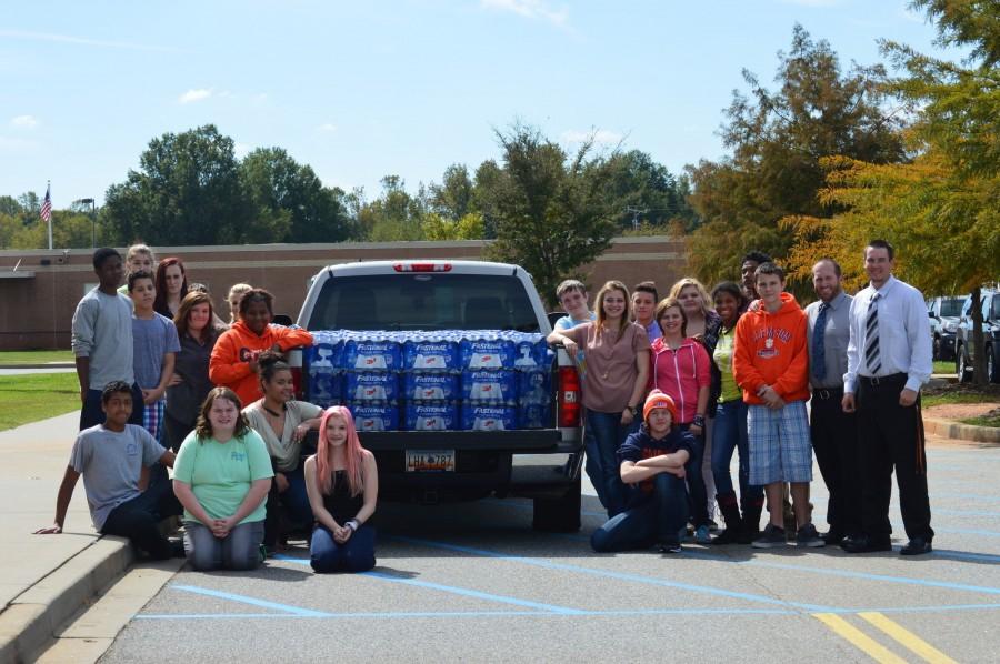 Chapman's Leadership Academy finishes loading bottled water to be taken to Columbia. Students and teachers raised money to buy bottled water for those affected by the recent flooding. 