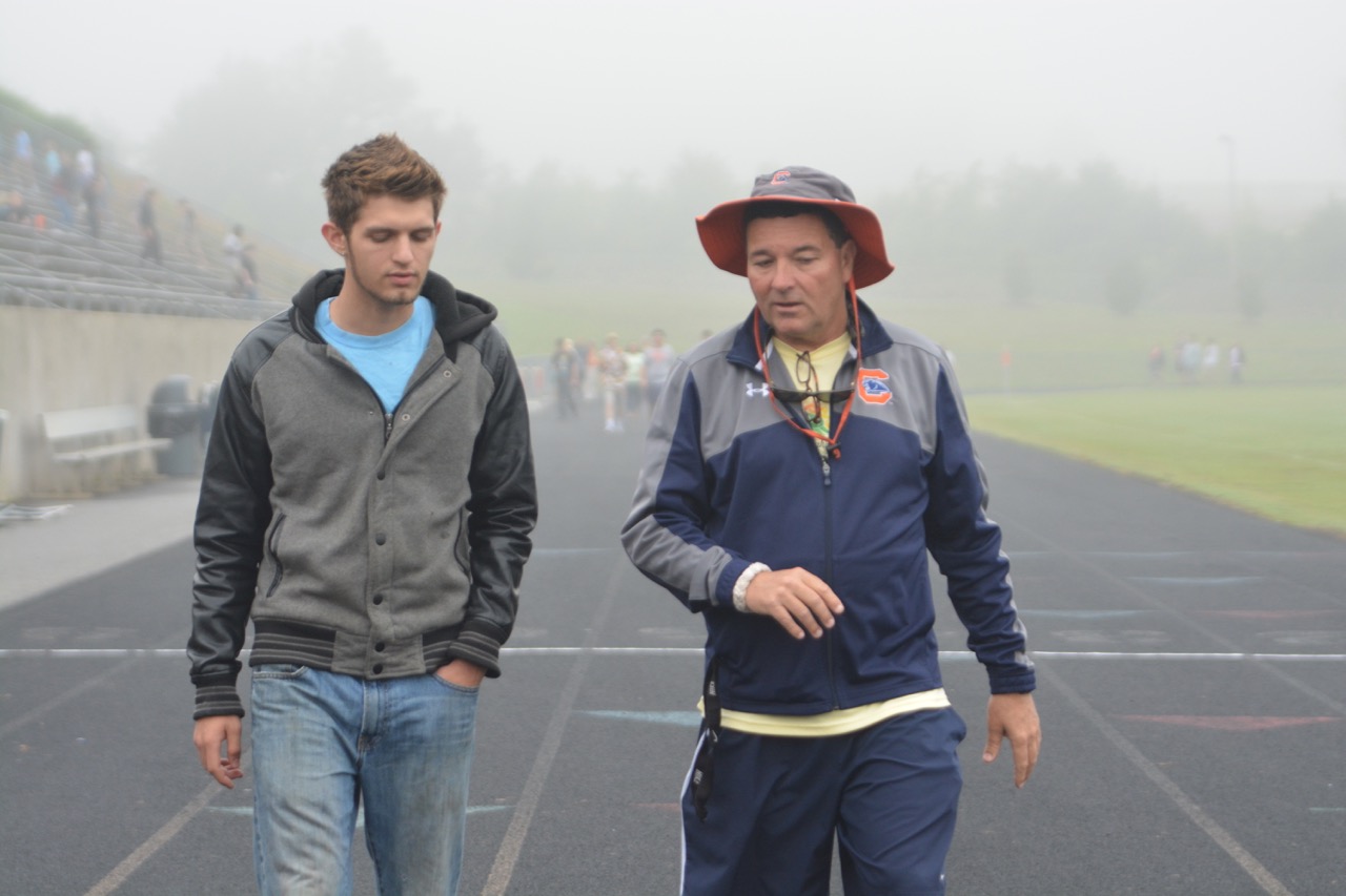Senior Michael Tessnear and soccer coach Will Maley walk and talk during Maleys final 12-hour walk.