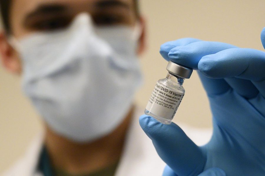 Army Spc. Angel Laureano holds a vial of the COVID-19 vaccine, Walter Reed National Military Medical Center, Bethesda, Md., Dec. 14, 2020