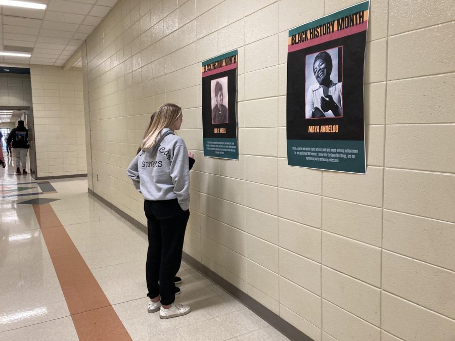 Students stop to examine the posters of Black American icons that are placed on the 400 hall. The posters are one way FAR is celebrating Black History Month.