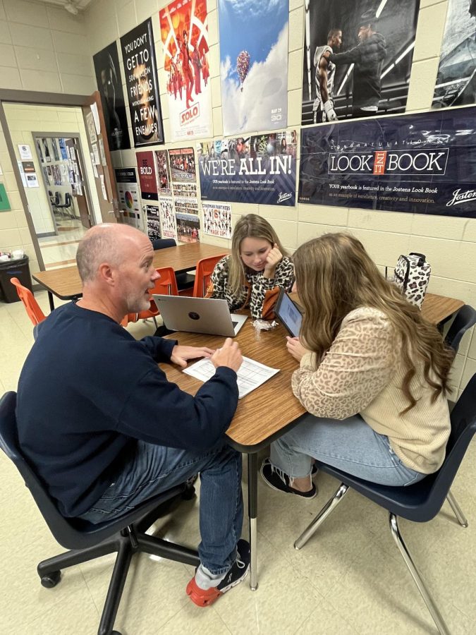 Journalism teacher Alex Hollis works with yearbook staff members. Hollis is known for building strong relationships. 