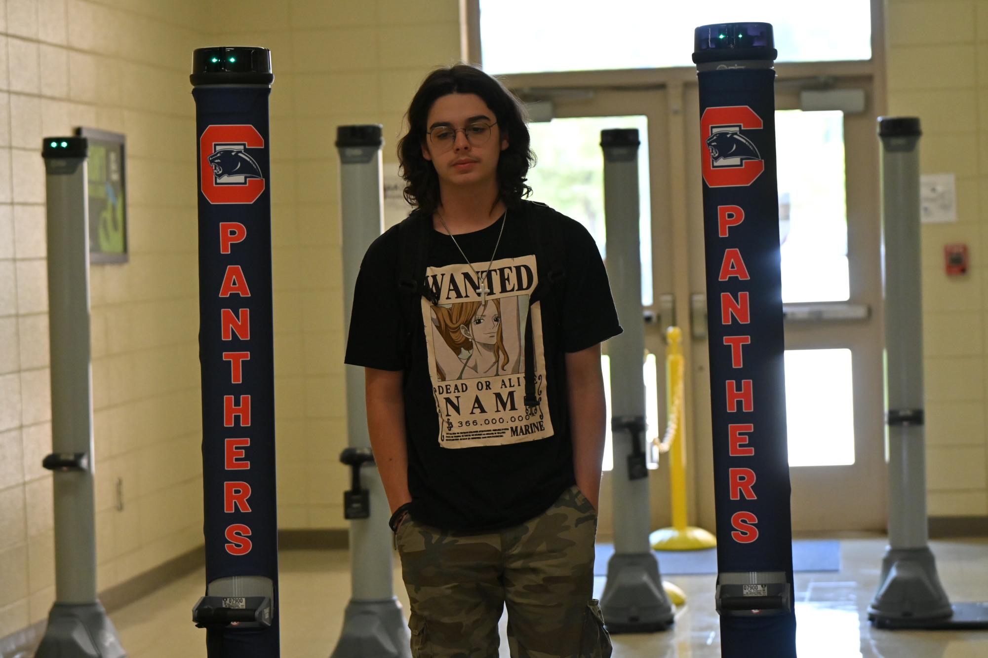 Junior Graham Boyd enters through the weapon detection system at the student parking entrance.