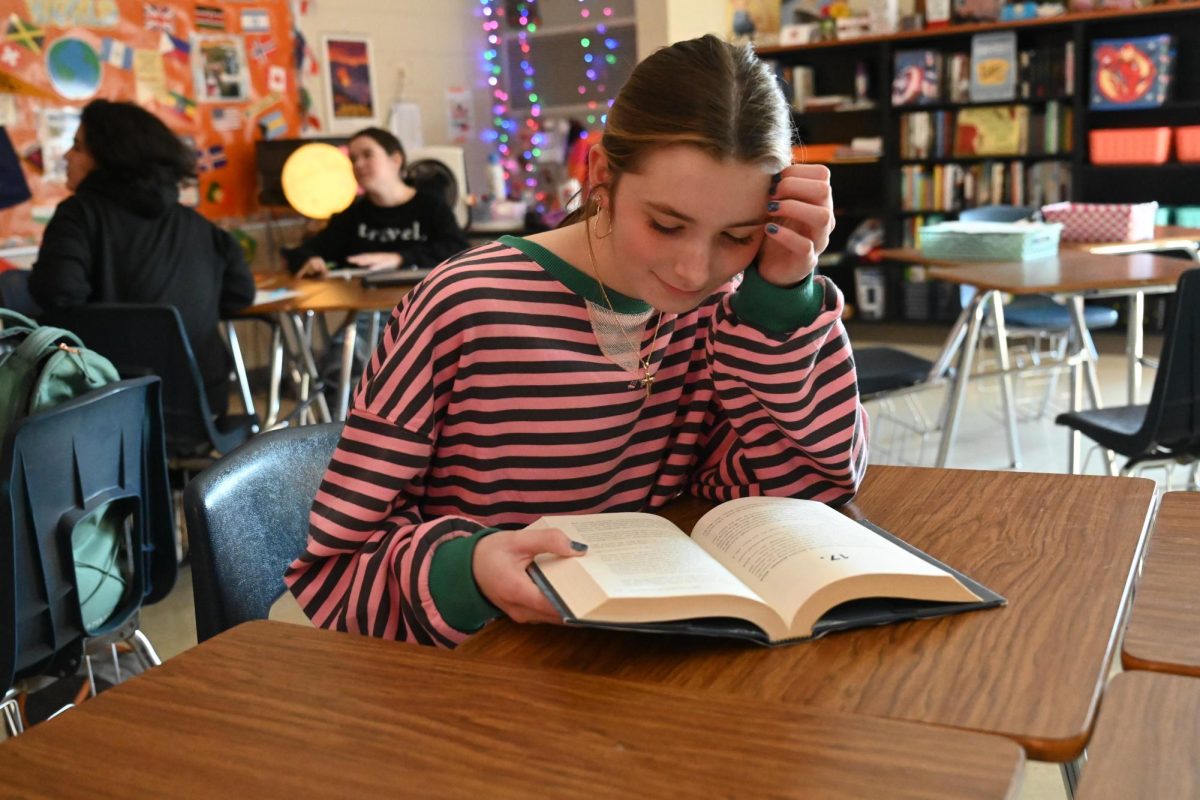 Freshman Sarah Gaskins reads after finishing her work.