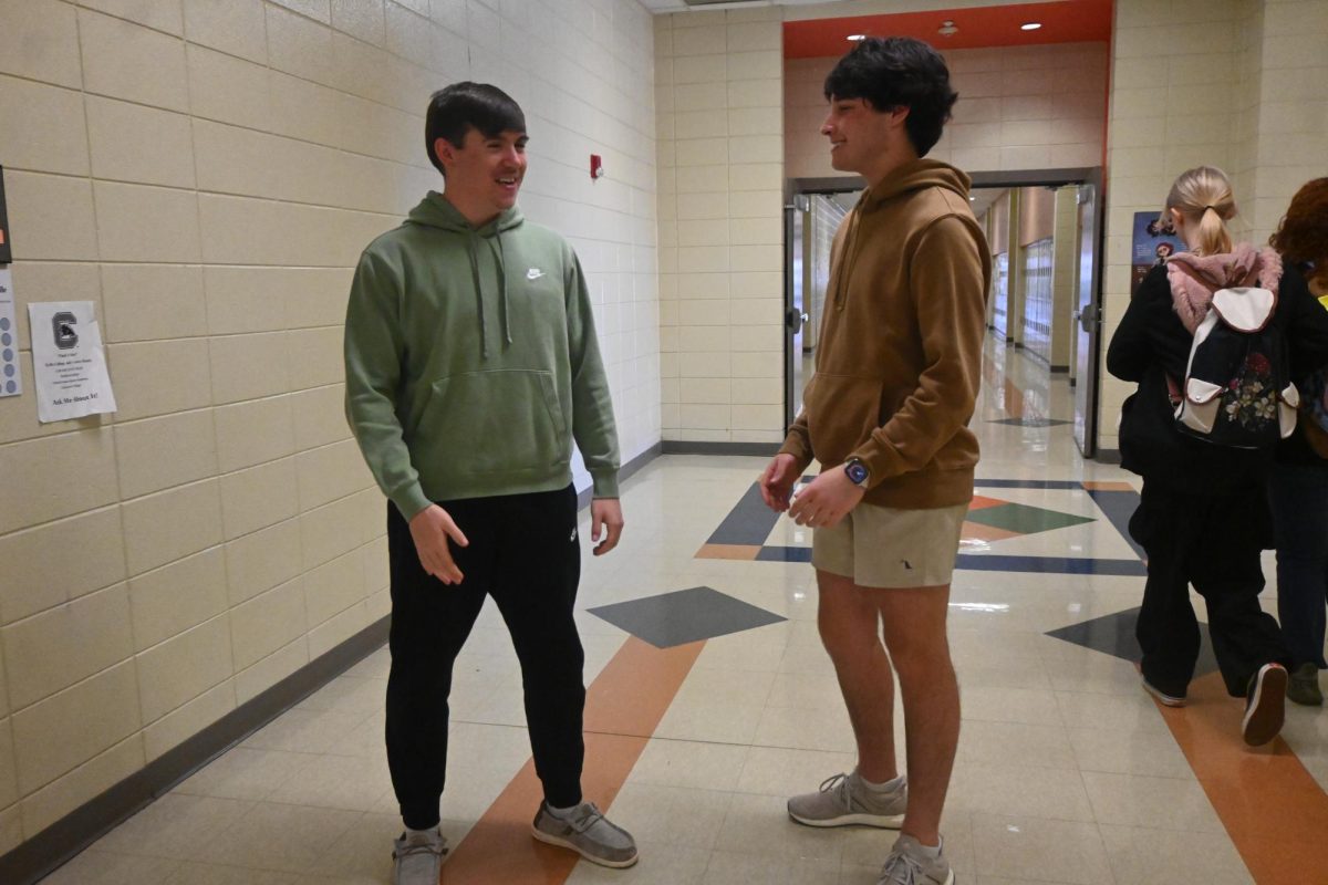 Junior Grayson Pruitt (right) talks to his friend, junior Hawken Smith. Pruitt wears shorts in all weather.