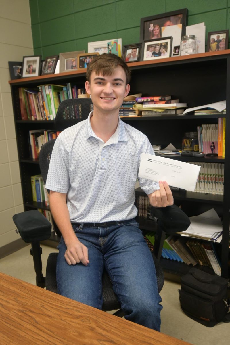Senior Sam Williams holds up his National Merit Scholarship semifinalist letter. Williams is one of the only students in Chapman history to receive this honor.
